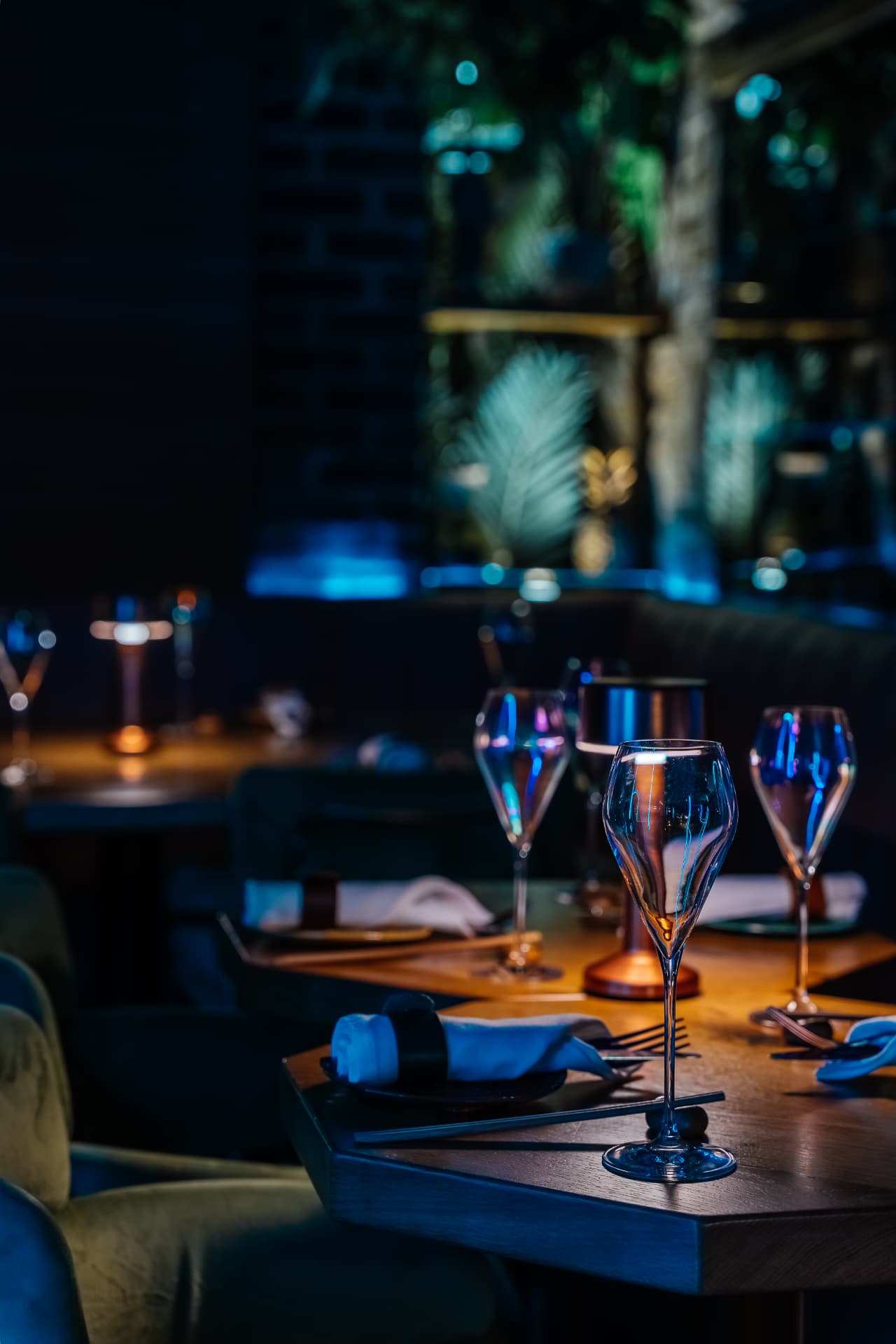Glassware set on a candlelit table inside Cache Cache