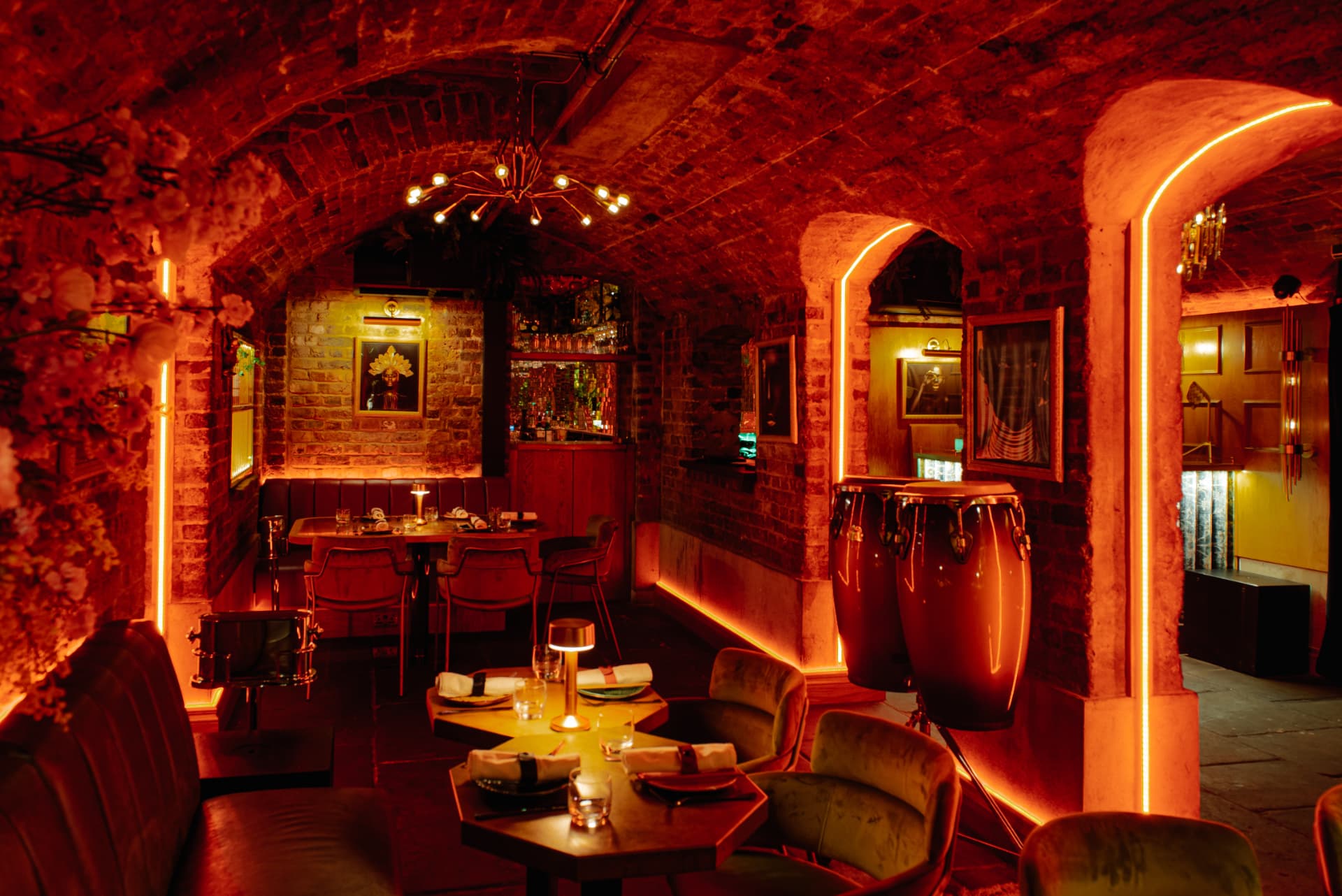 Amber-lit dining room beneath the brick arches of Cache Cache